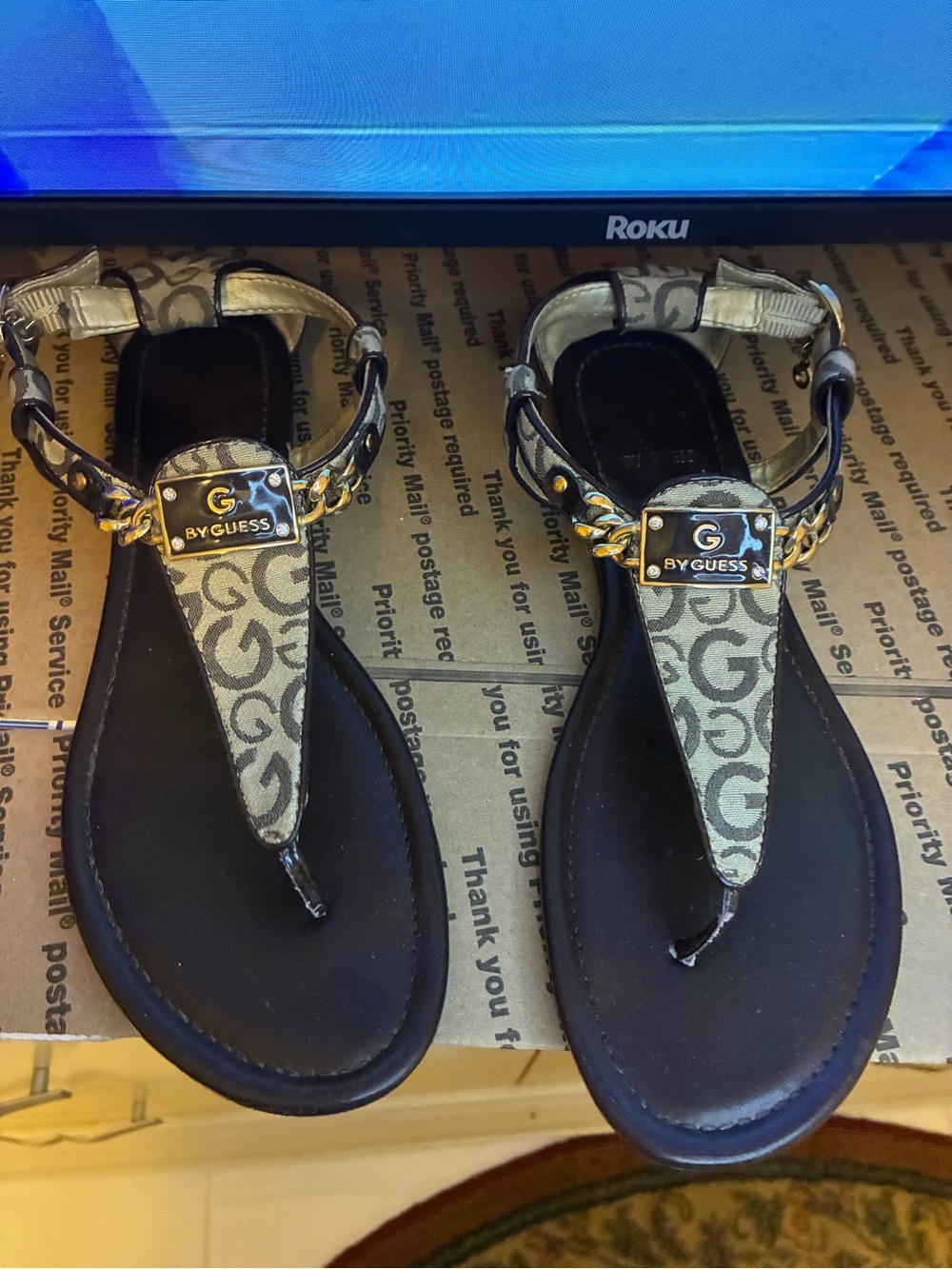 GUESS Tan Logo T‑Strap Sandals with Gold Plaque